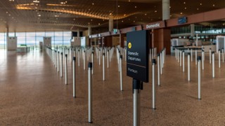 Designing Airport Queue Management Systems for Changing Passenger Volumes
